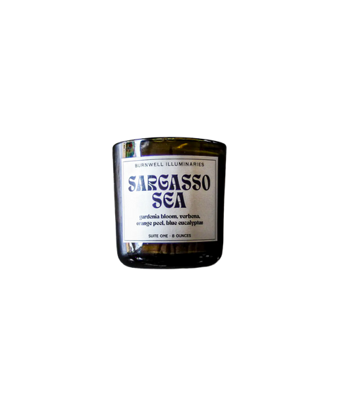 A Barnaby Black Burnwell Illuminaries Sargasso Sea candle in an amber glass jar.