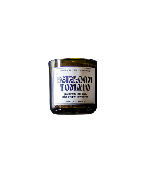 A Barnaby Black Burnwell Illuminaries Heirloom Tomato candle in an amber glass jar.