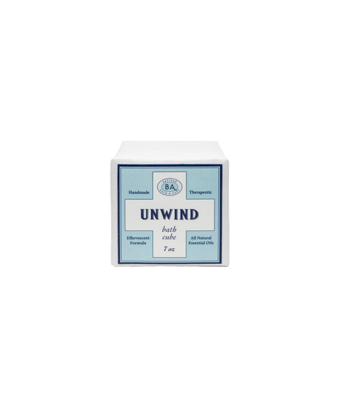 Baudelaire Unwind bath cube in a white package with a blue label, indicating natural ingredients.