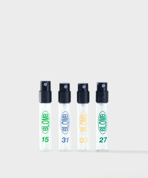 Four clear BLOMB perfume sample spray vials lined in a row with 15, 31, 03, and 27 printed on them.