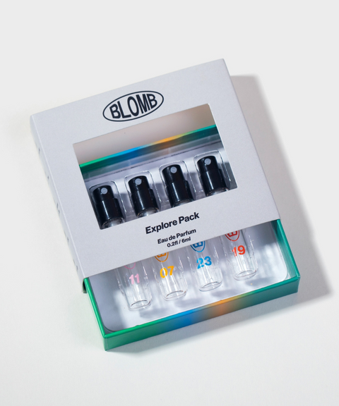A BLOMB Explore Pack four perfume sample vials being pulled out of their box.