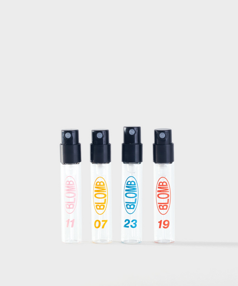 Four clear BLOMB perfume sample spray vials lined in a row with 15, 31, 03, and 27 printed on them.