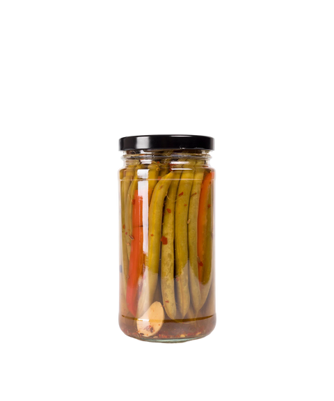 A glass jar of Dilly Dilly Provisions pickled dilly beans with a black lid.