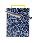A rectangular kitchen cutting board with a black and white marbled pattern and a bright yellow handle, shown with a chef's knife laid diagonally across the top surface on a plain white background.