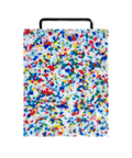 A rectangular plastic cutting board with a black metal handle, featuring a white base covered in dense multicolored confetti-like speckles in blue, red, yellow, and green, shown on a plain white background.