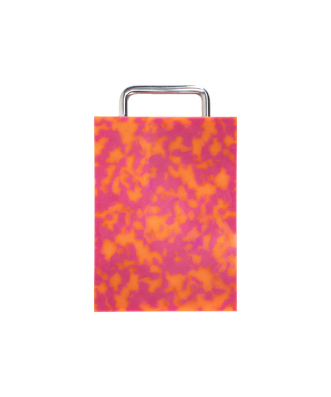 A rectangular plastic cutting board with a pink and orange marbled pattern and silver chrome metal handle, shown on a plain white background.