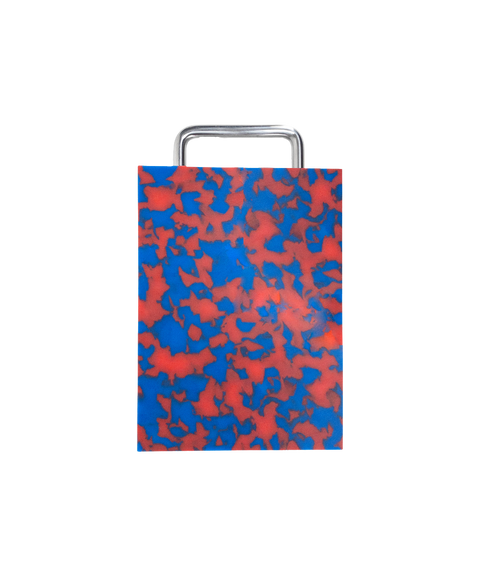 A rectangular plastic cutting board with a red and blue marbled pattern and silver chrome metal handle, shown on a plain white background.