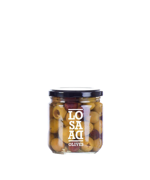 A glass jar of Losada Pitted Olives featuring green and purple olives inside.