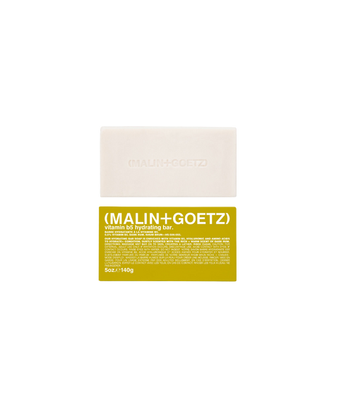 Malin+Goetz Vitamin B5 hydrating soap bar in rum scent above its yellow product box.