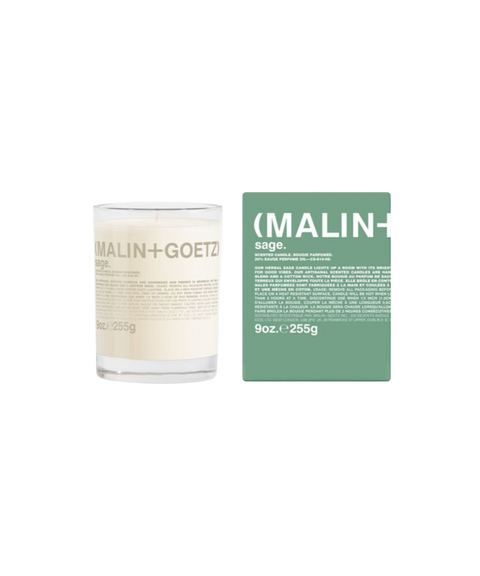 A Malin+Goetz Sage candle in a clear glass jar next to its mint green box.