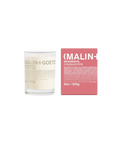 A Malin+Goetz Strawberry candle in a clear glass jar next to its pink box.