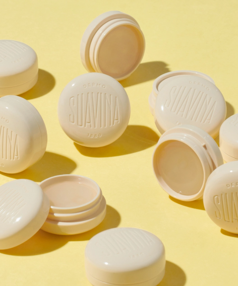 Suavina original lip balm in cream-colored pots on a yellow background.