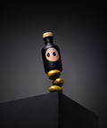 A black bottle of Yiayia & Friends olive oil with a wood stopper balanced on three green olives on a pedestal.